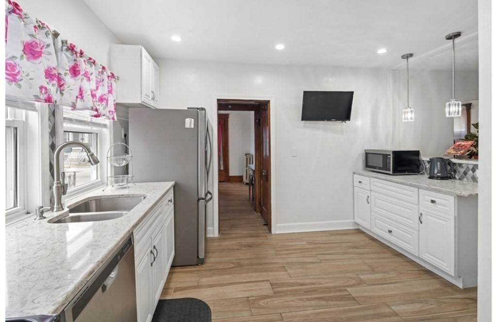 55 Austin Street Boston, MA 02136 - Photo 8 of 24 a kitchen with granite countertop a sink stainless steel appliances and cabinets