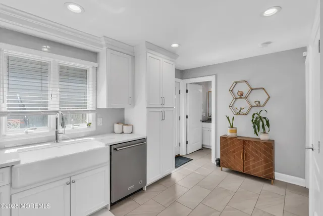 a bathroom with a sink double vanity mirror and a bathtub