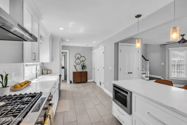 a kitchen with stainless steel appliances granite countertop a stove and a sink