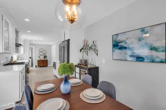 a dining room with furniture and wooden floor
