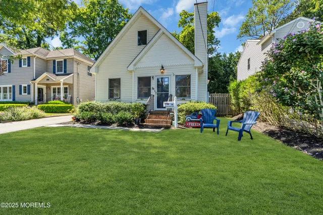 a front view of house with yard and outdoor seating