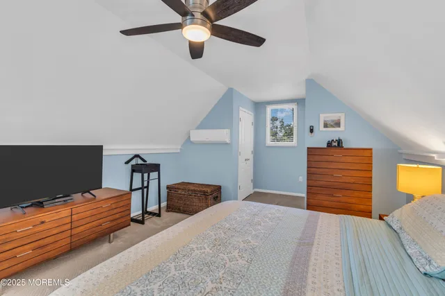 a bedroom with bed and wooden floor