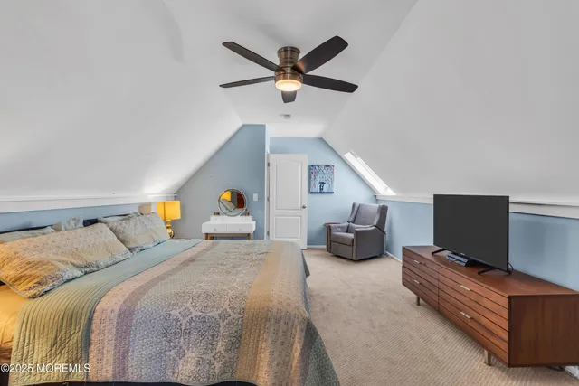 a bed room with a bed and a television