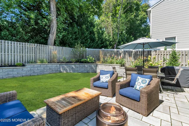 a view of a backyard with furniture and a garden