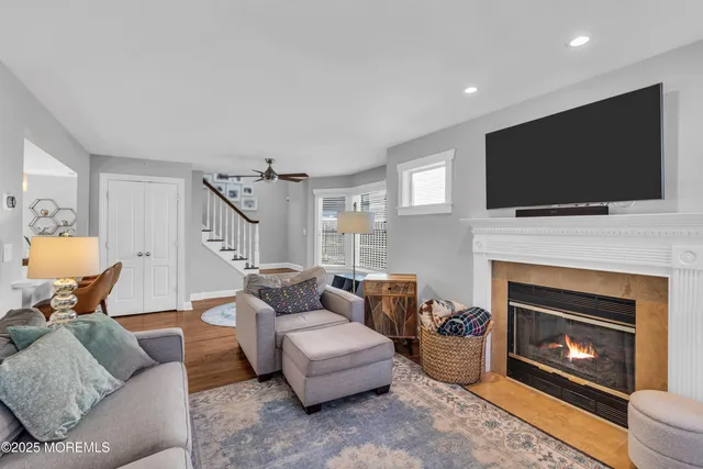a living room with furniture a flat screen tv and a fireplace