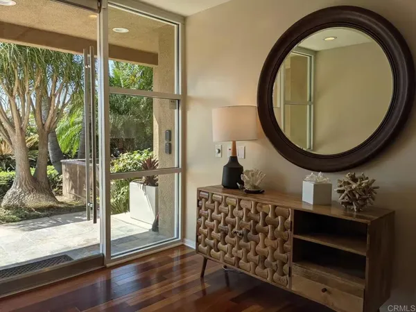 a view of entryway and hall with wooden floor