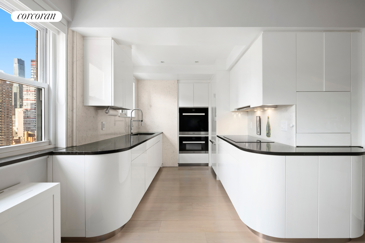 345 East 56th Street, Unit 21F Manhattan, NY 10022 - Photo 5 of 9 a large white kitchen with wooden floor