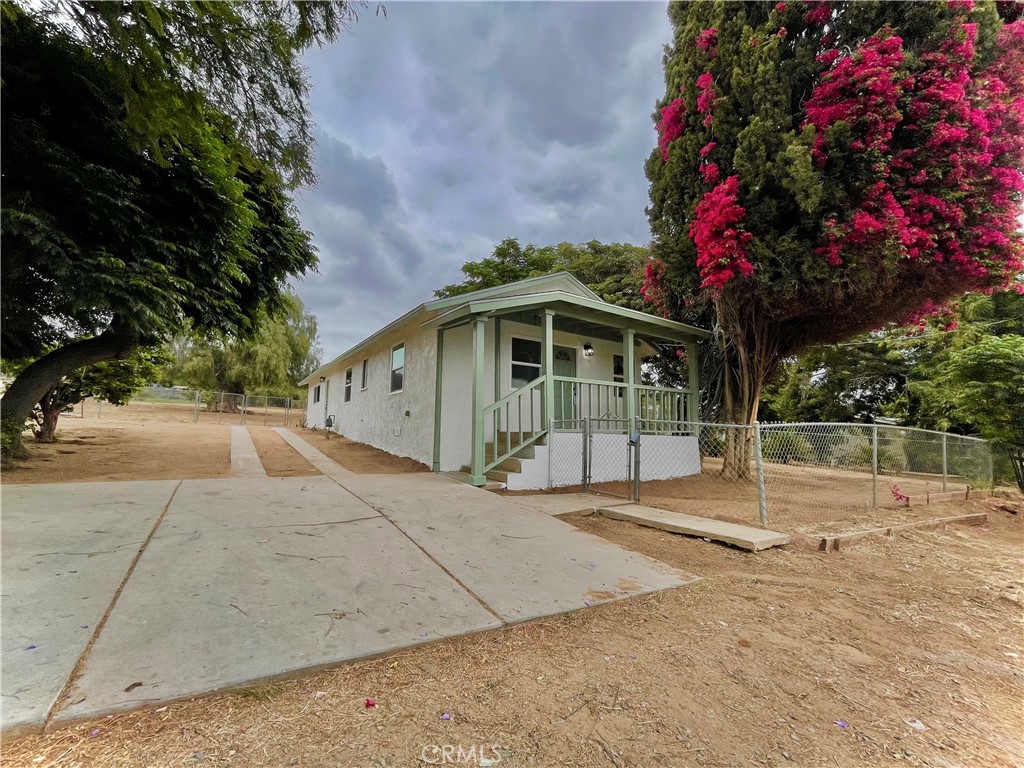 10531 Gramercy Place Riverside, CA 92505 - Photo 1 of 1 a front view of a house with a yard and garage