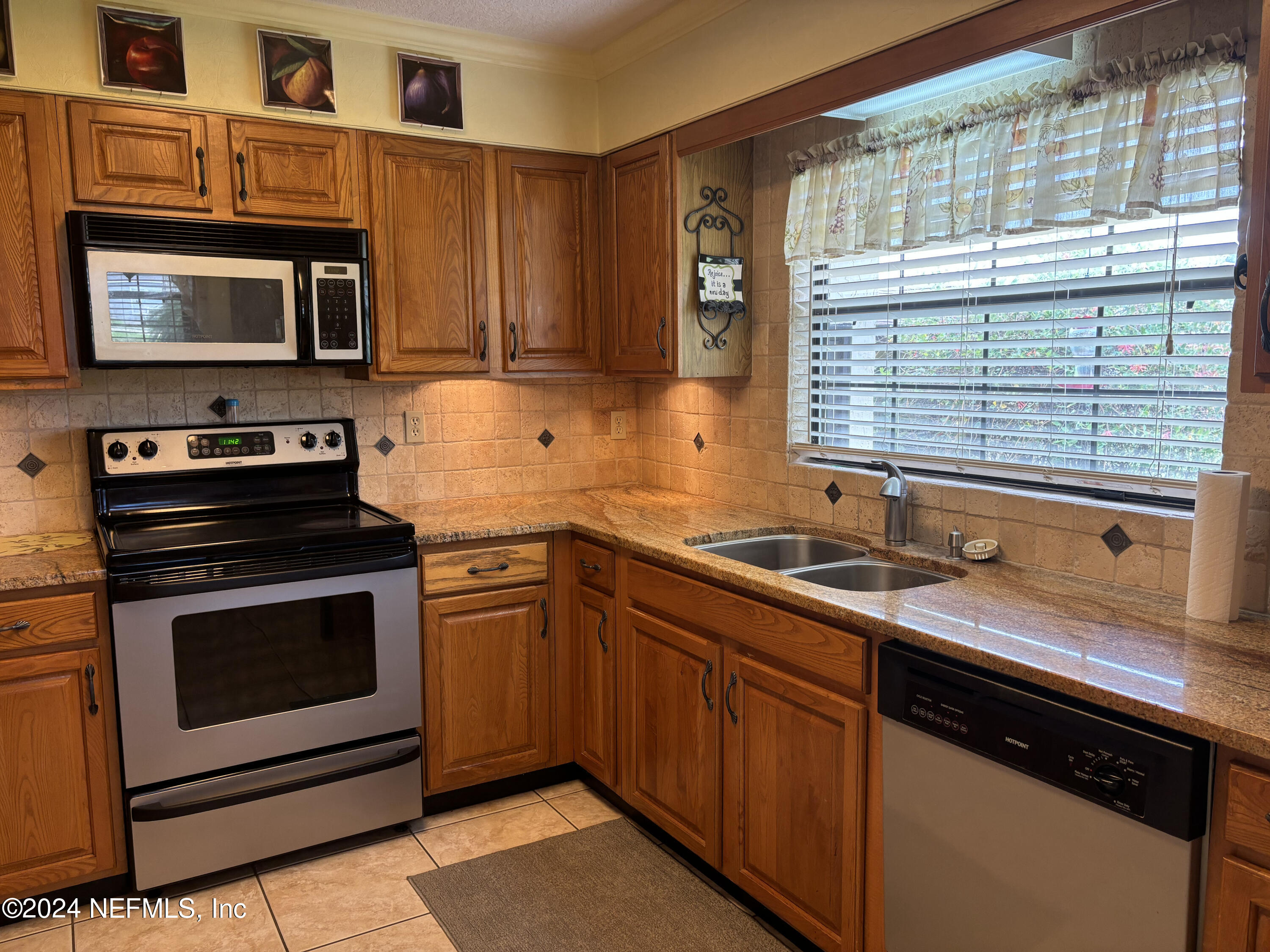 2700 New Berlin Road Jacksonville, FL 32226 - Photo 17 of 42 a kitchen with granite countertop a sink stainless steel appliances and cabinets