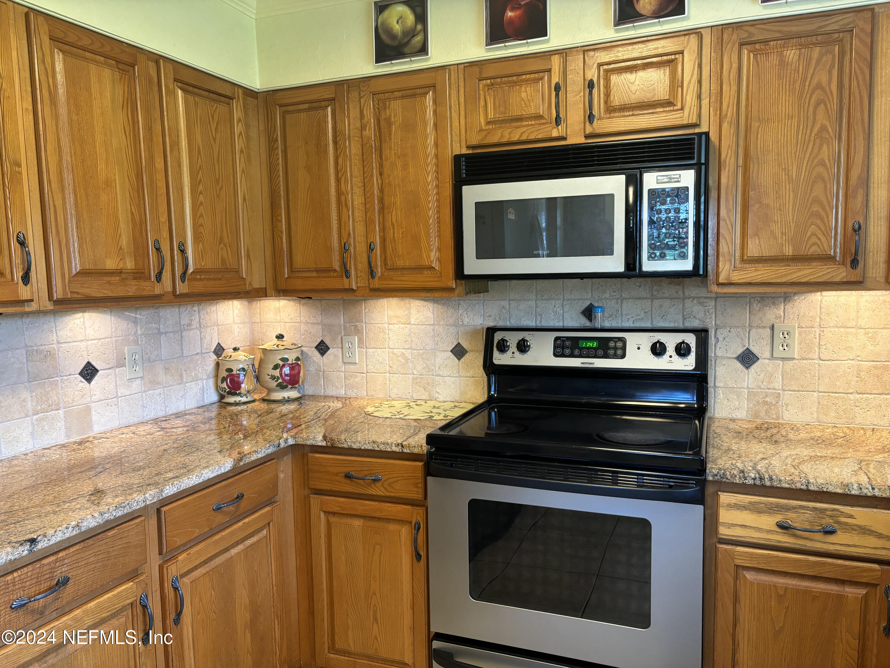 2700 New Berlin Road Jacksonville, FL 32226 - Photo 18 of 42 a kitchen with stainless steel appliances granite countertop a stove microwave and cabinets