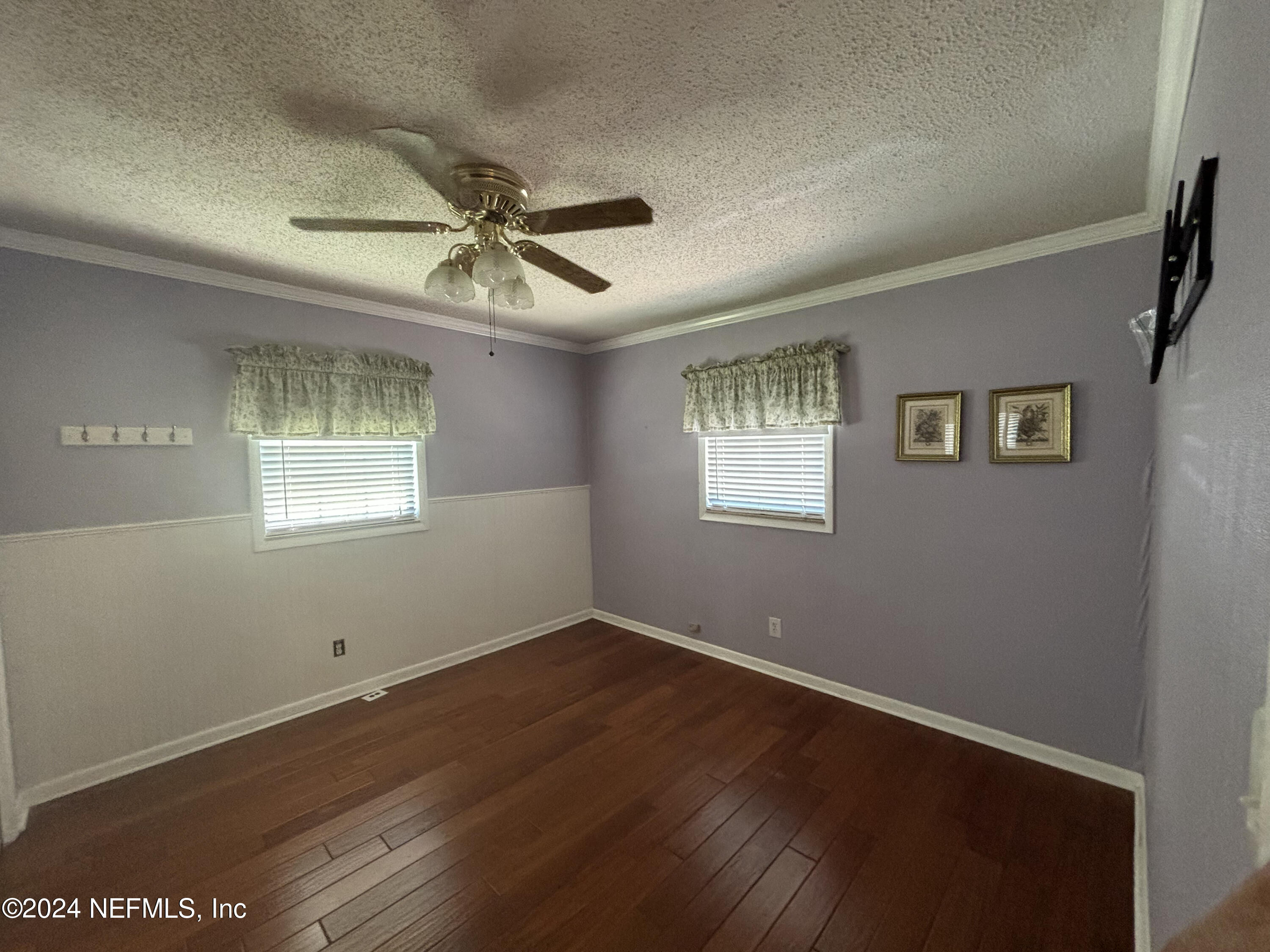2700 New Berlin Road Jacksonville, FL 32226 - Photo 23 of 42 a view of a livingroom with a window a ceiling fan and wooden floor