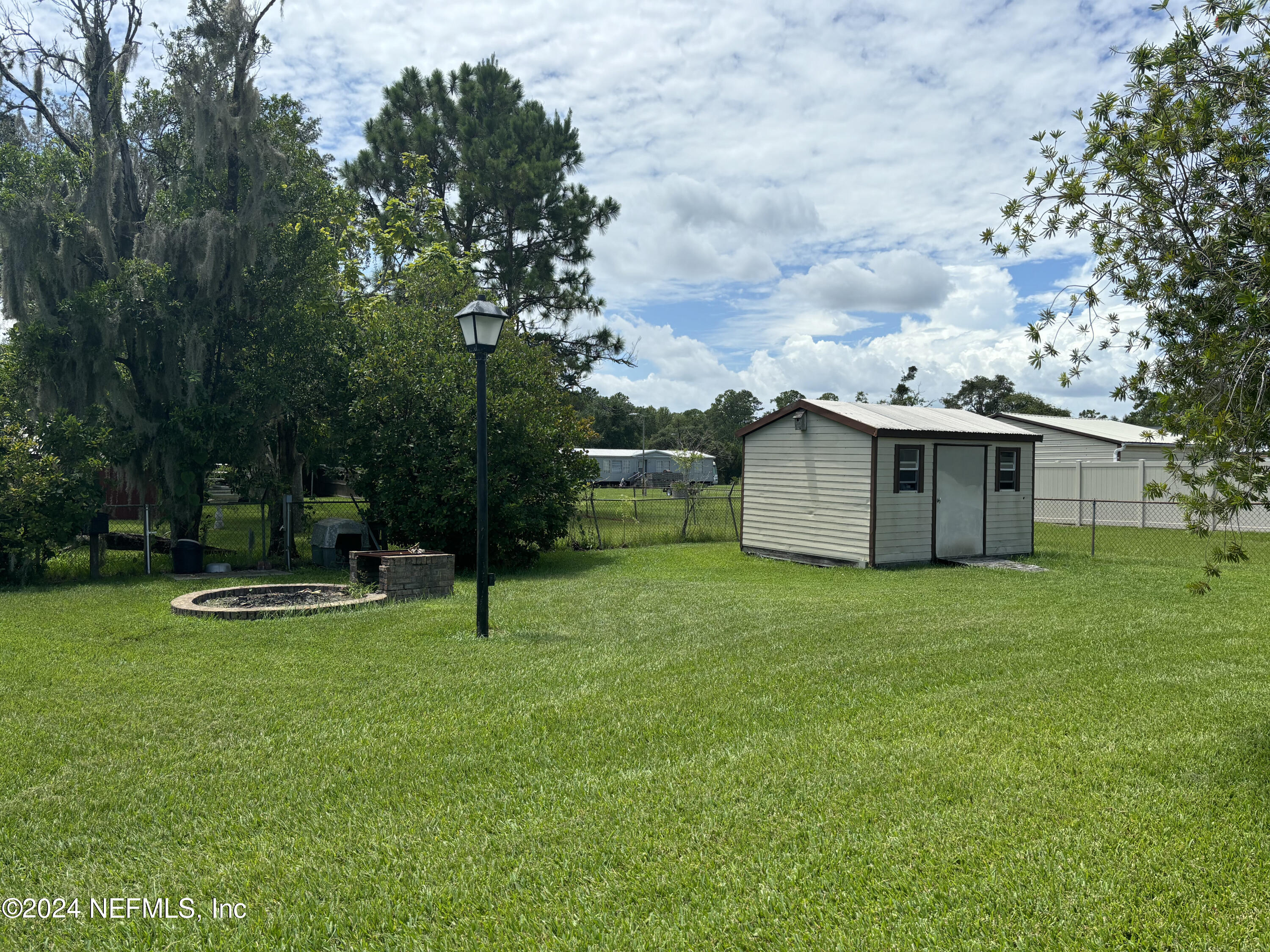 2700 New Berlin Road Jacksonville, FL 32226 - Photo 40 of 42 a backyard of a house with table and chairs