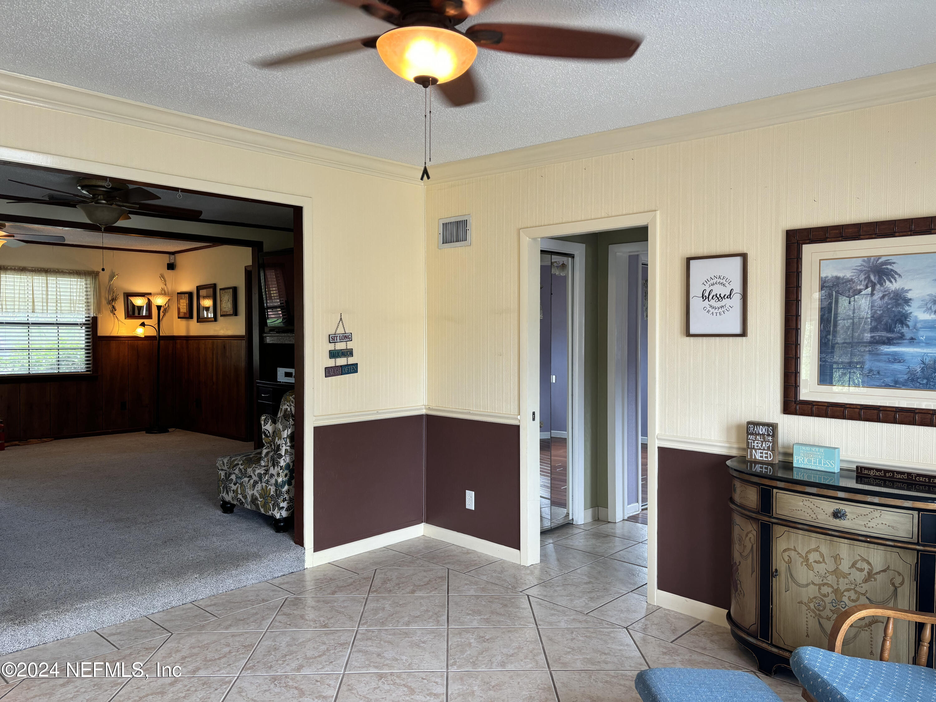 2700 New Berlin Road Jacksonville, FL 32226 - Photo 10 of 42 a living room with furniture and a chandelier