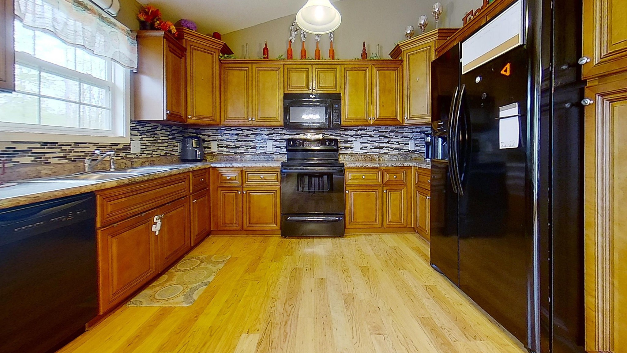 1110 Toomey Road Oneida, TN 37841 - Photo 11 of 30 a kitchen with stainless steel appliances granite countertop a stove a sink and a microwave