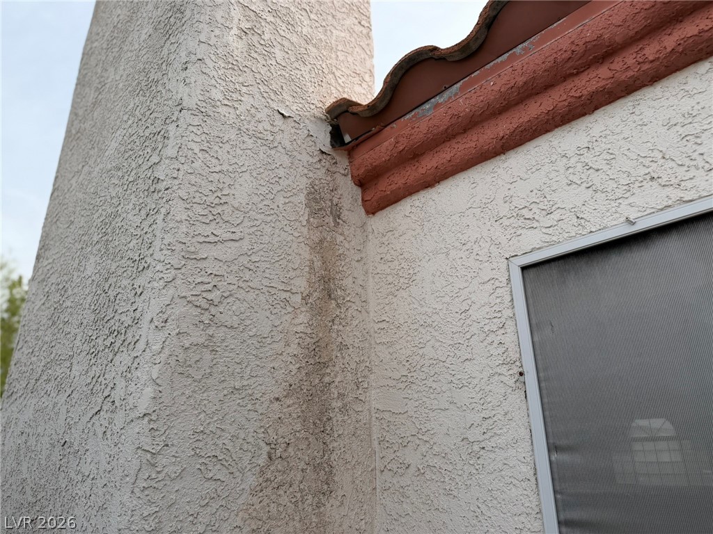 277 Gentle Bay Avenue Henderson, NV 89074 - Photo 15 of 43 This exterior wall features textured stucco with a window and tiled roof accent.