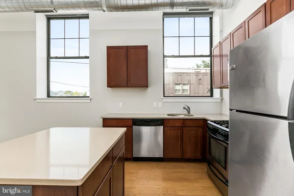 a kitchen with stainless steel appliances a refrigerator sink and cabinets