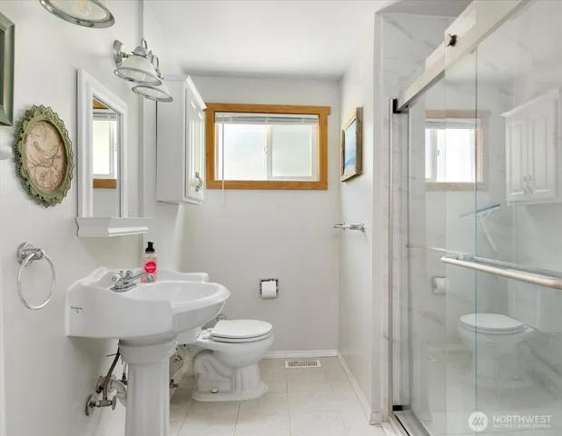 a bathroom with a sink toilet and shower