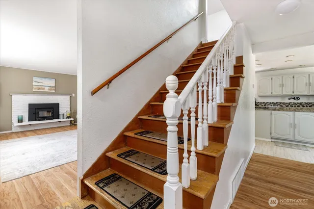 a view of an entryway with wooden floor and staircase