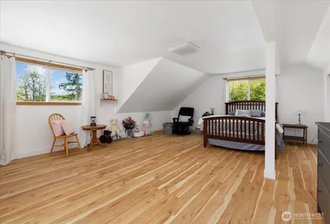 a view of a room with furniture wooden floor and windows