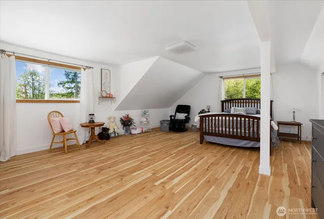 a view of a room with furniture wooden floor and windows