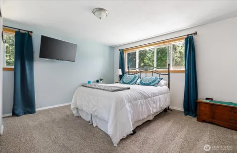 a bed sitting in a bedroom next to a window