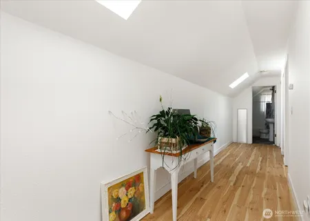 a living room with furniture and potted plant