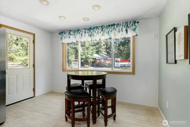 a view of a dining room with furniture window and outside view