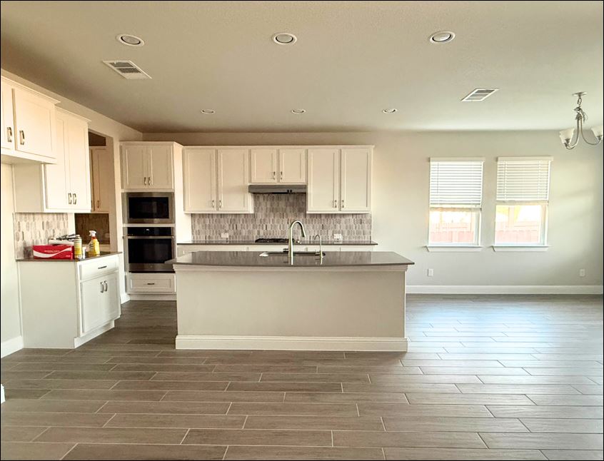 109 Rocky River Road Georgetown, TX 78628 - Photo 4 of 10 A well-lit kitchen with sleek countertops and stylish tile flooring.