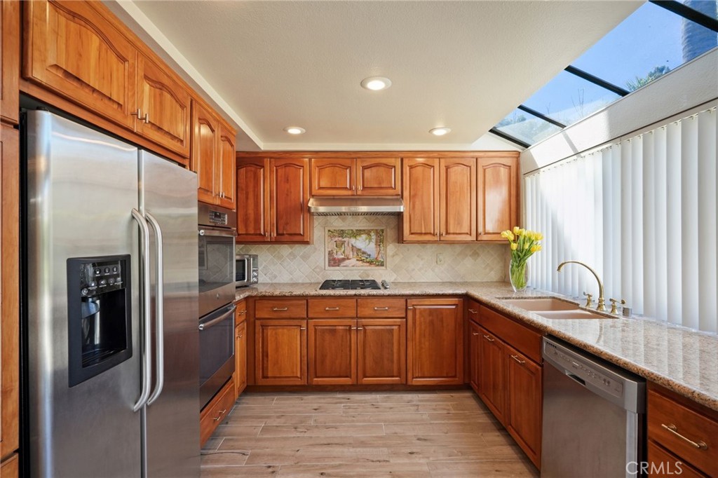 19565 Turtle Springs Way Porter Ranch, CA 91326 - Photo 4 of 96 SPACIOUS KITCHEN WITH STAINLESS STEEL APPLIANCES
