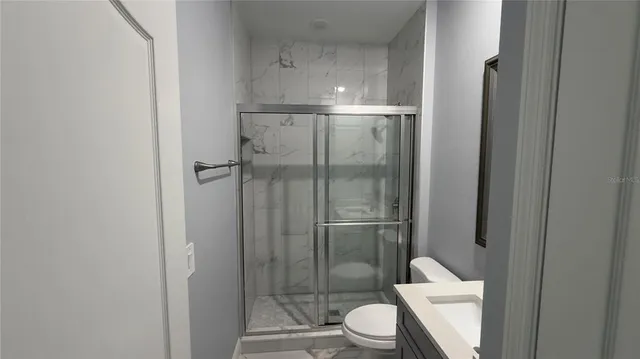 a bathroom with a toilet and a shower