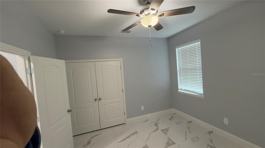 706 South Thacker Avenue Kissimmee, FL 34741 - Photo 26 of 36 a view of empty room with window and ceiling fan