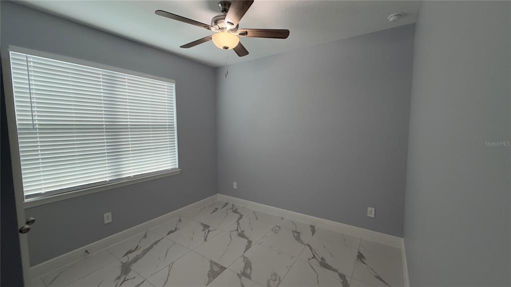 706 South Thacker Avenue Kissimmee, FL 34741 - Photo 27 of 36 an empty room with a window and a fan