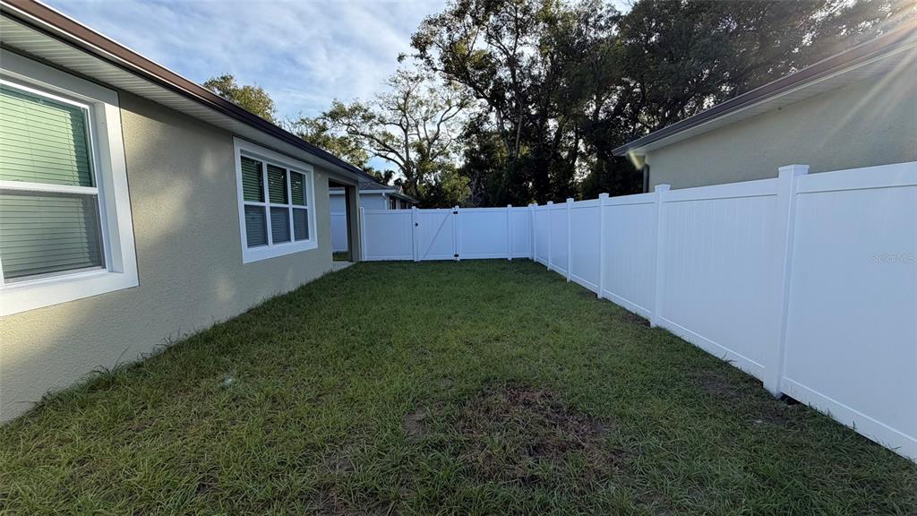 706 South Thacker Avenue Kissimmee, FL 34741 - Photo 4 of 36 a view of backyard with porch