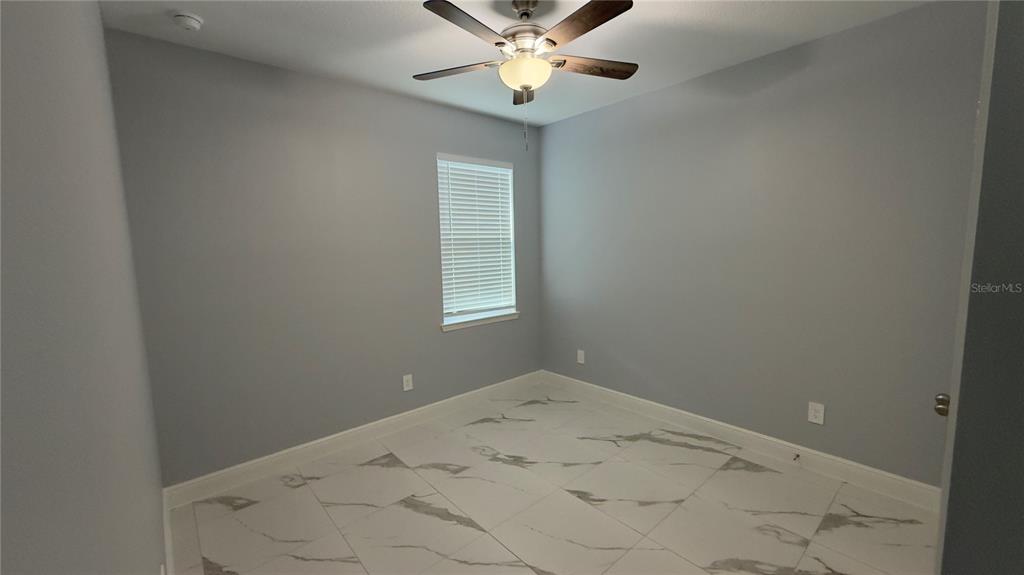 706 South Thacker Avenue Kissimmee, FL 34741 - Photo 10 of 36 a view of a hallway with a chandelier fan