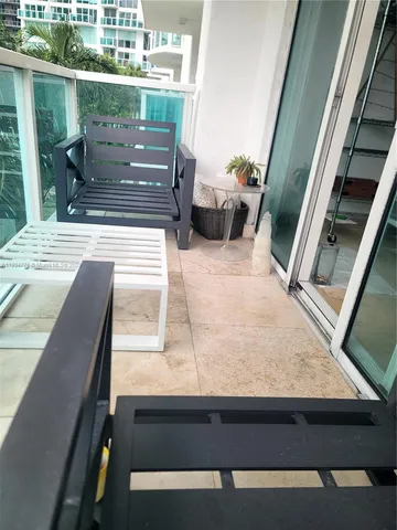 a room with furniture and kitchen view