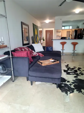 a balcony with table and chairs and plants