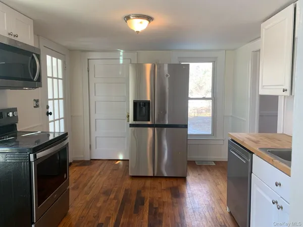 a kitchen with stainless steel appliances granite countertop a refrigerator and a stove top oven