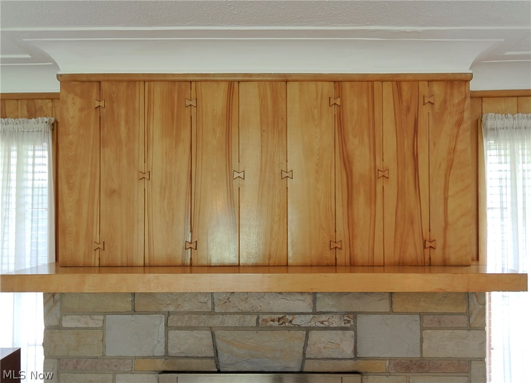 Living room wood paneling has an interesting interlocking design.