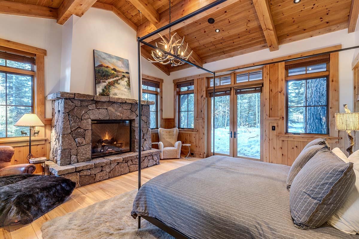 8458 Valhalla Drive Truckee, CA 96161 - Photo 14 of 20 a spacious bedroom with a bed and a fireplace