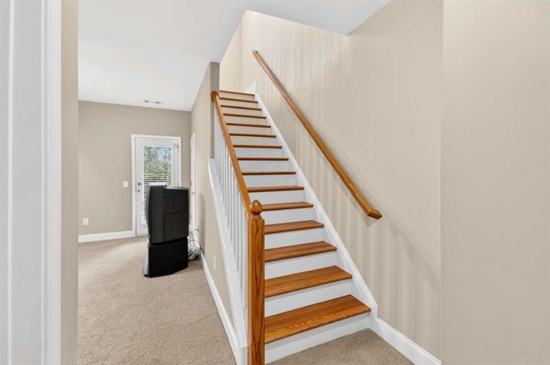 2660 Colgan Court Southeast Atlanta, GA 30317 - Photo 16 of 50 a view of staircase with wooden floor and white walls