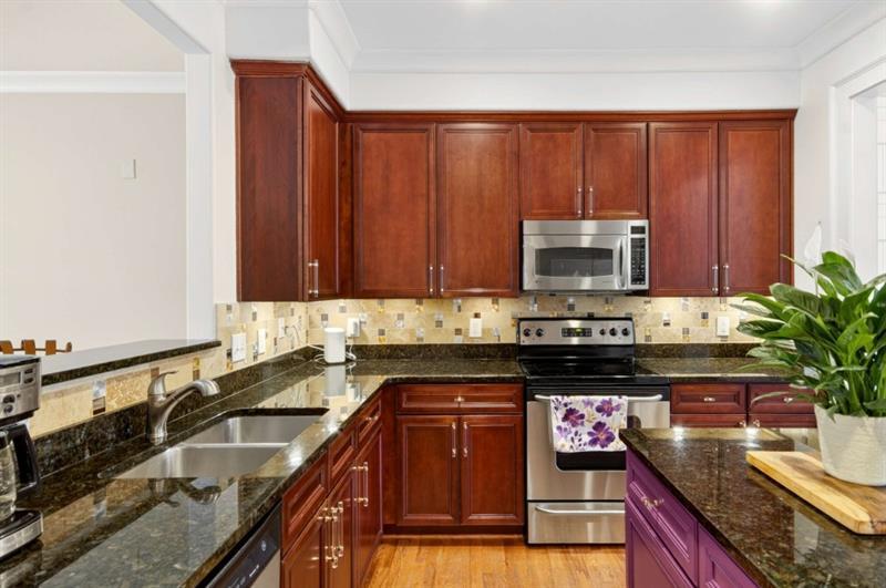 2660 Colgan Court Southeast Atlanta, GA 30317 - Photo 19 of 50 a kitchen with granite countertop stainless steel appliances a sink a counter space and cabinets