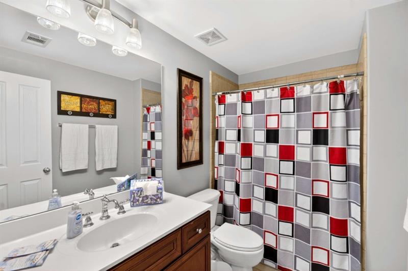 2660 Colgan Court Southeast Atlanta, GA 30317 - Photo 26 of 50 a bathroom with a sink a toilet a shower and a mirror