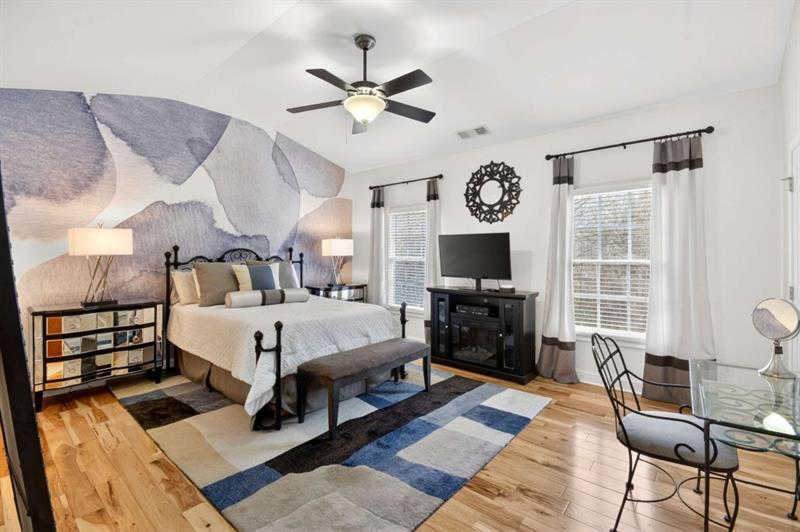 2660 Colgan Court Southeast Atlanta, GA 30317 - Photo 28 of 50 a spacious bedroom with a bed and a flat screen tv