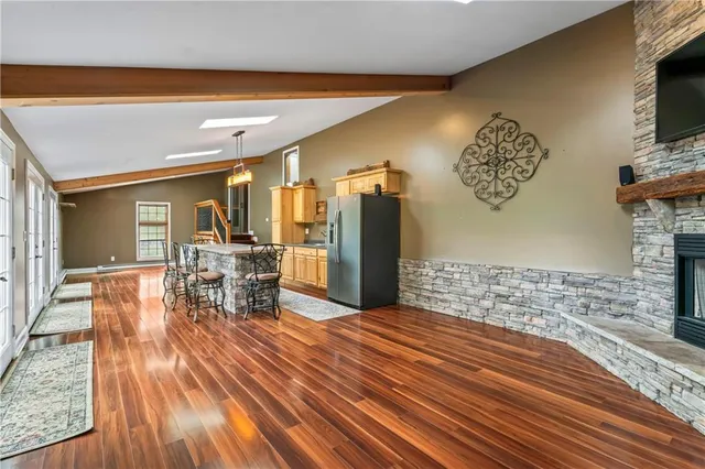 a view of a room with furniture and wooden floor