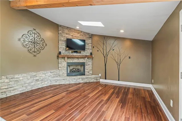 a view of empty room with a fireplace