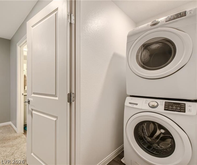 12110 Midnight Pine Road, Unit 3 Las Vegas, NV 89183 - Photo 11 of 13 Streamlined laundry area with a stacked washer and dryer unit, maximizing utility in a compact space.