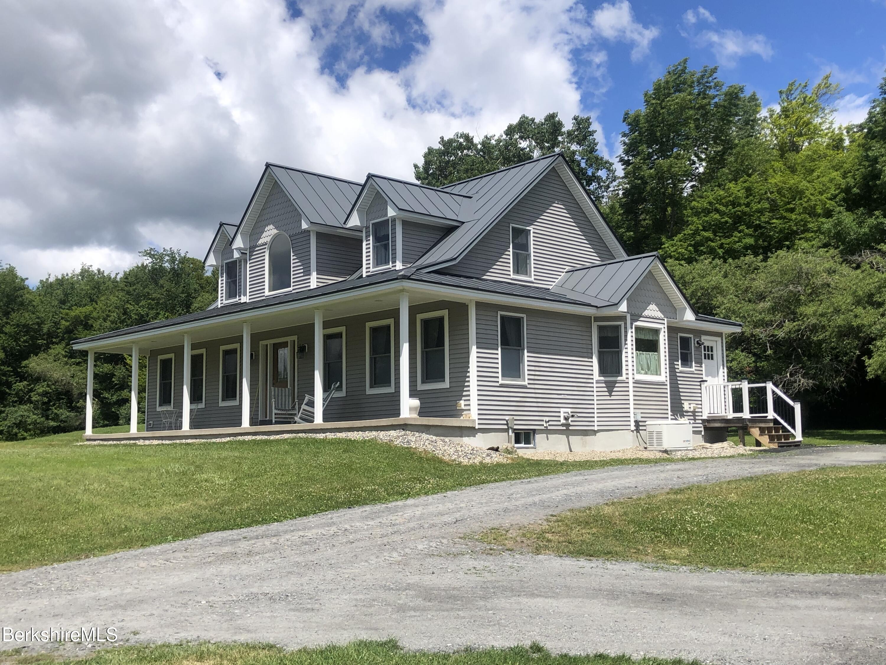 1387 East Windsor Road Windsor, MA 01270 - Photo 1 of 38 a front view of a house with a yard