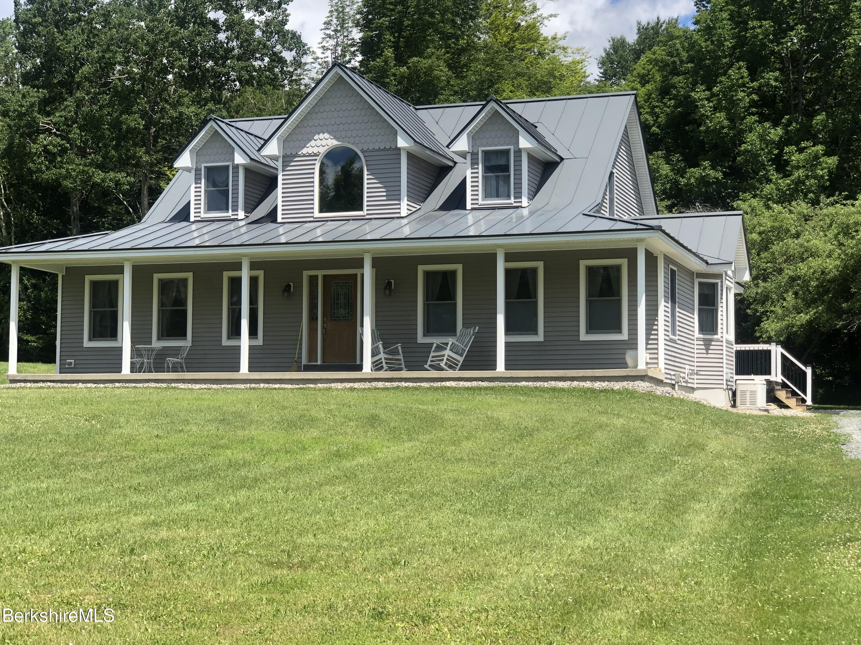1387 East Windsor Road Windsor, MA 01270 - Photo 2 of 38 a front view of a house with a garden