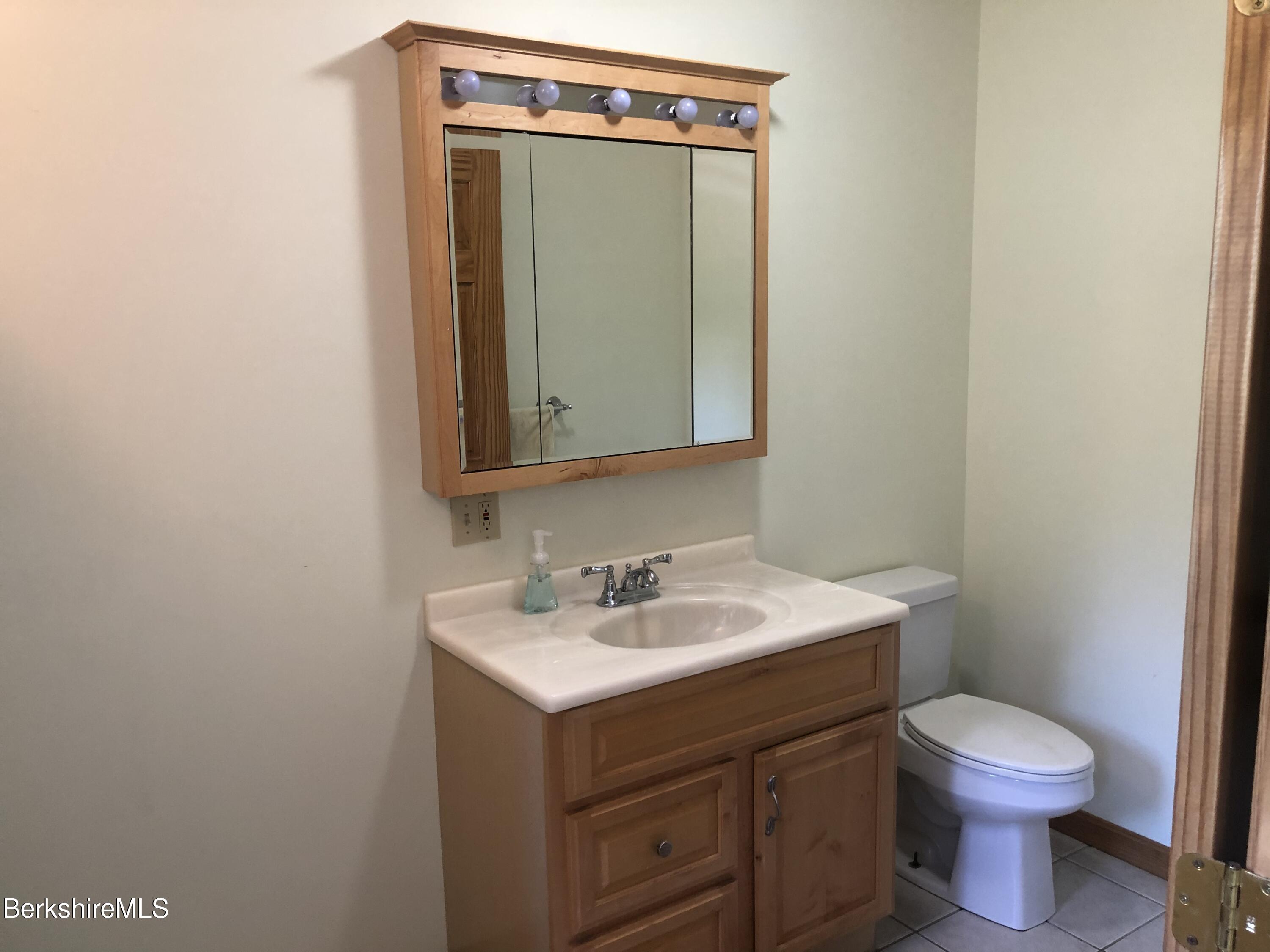 1387 East Windsor Road Windsor, MA 01270 - Photo 26 of 38 a bathroom with a toilet sink and mirror