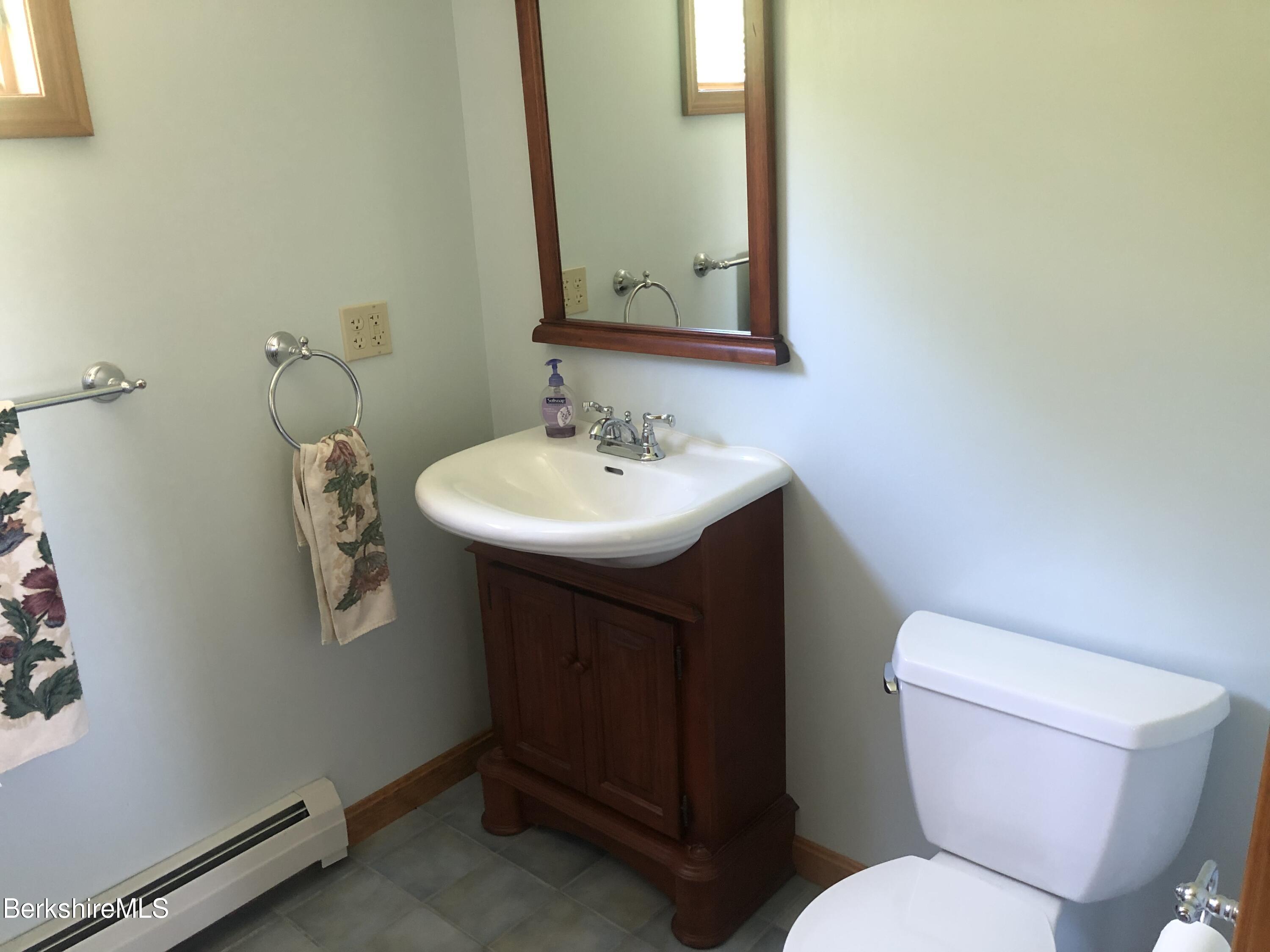 1387 East Windsor Road Windsor, MA 01270 - Photo 28 of 38 a bathroom with a toilet a sink and mirror